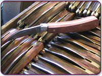 Assembled knives in a tray ready to be ground glazed and finished